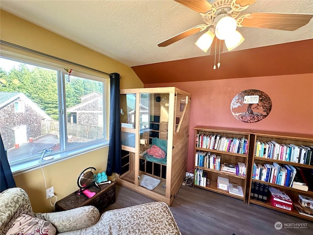 sitting room featuring hardwood / wood-style flooring, ceiling fan, lofted ceiling, and a textured ceiling