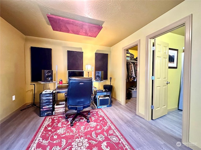 office area featuring a textured ceiling and light wood-type flooring