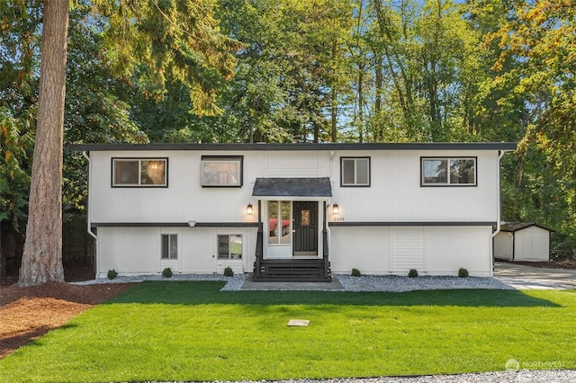 bi-level home featuring a shed and a front yard