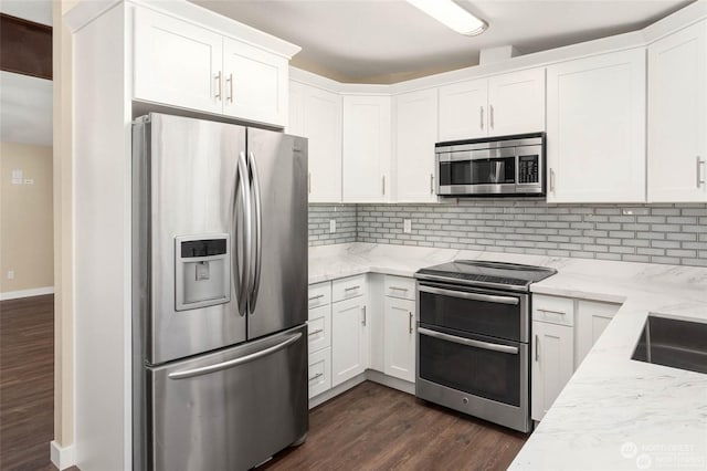 kitchen featuring white cabinetry, light stone countertops, and stainless steel appliances