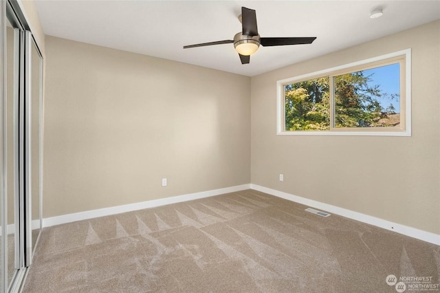 unfurnished bedroom featuring light colored carpet, a closet, and ceiling fan