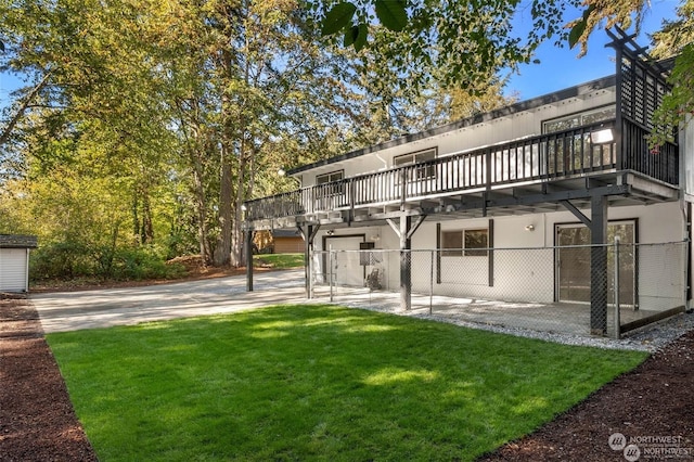 back of property featuring a yard and a garage