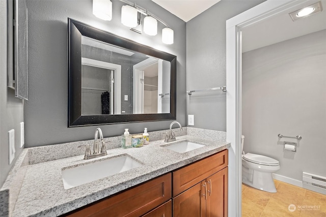 bathroom with toilet, vanity, a baseboard radiator, and tile patterned floors