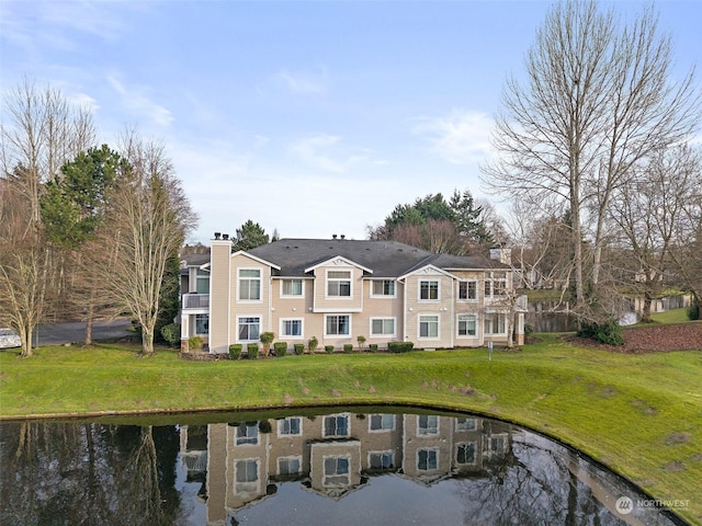 rear view of property with cooling unit, a water view, and a yard