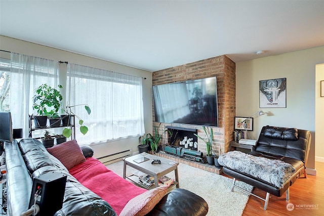 living room with a fireplace, a baseboard radiator, and wood-type flooring