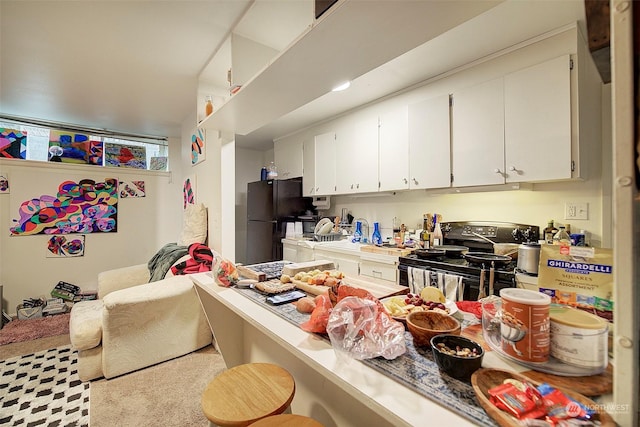 kitchen with white cabinetry and black appliances