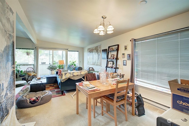 dining area featuring a chandelier, light colored carpet, vaulted ceiling, and a wealth of natural light