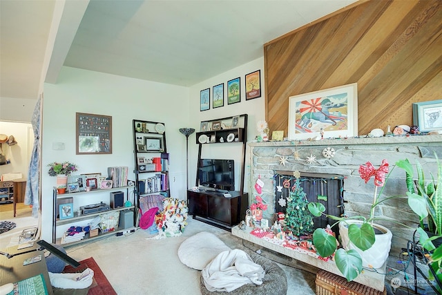 living room with wood walls and a fireplace