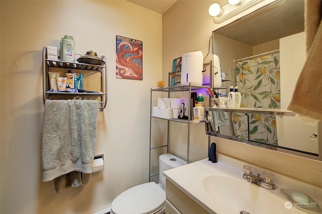 bathroom featuring vanity and toilet