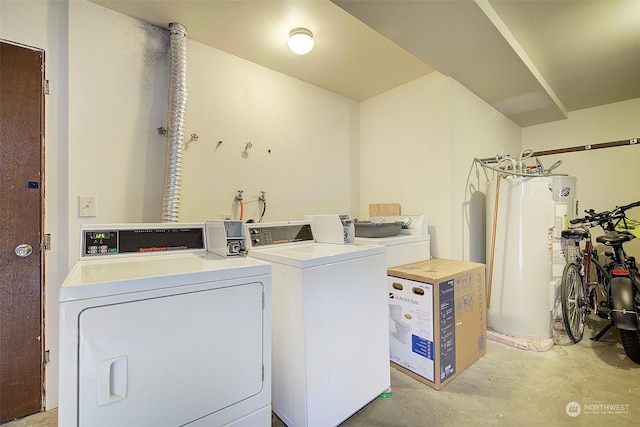 washroom featuring gas water heater and separate washer and dryer