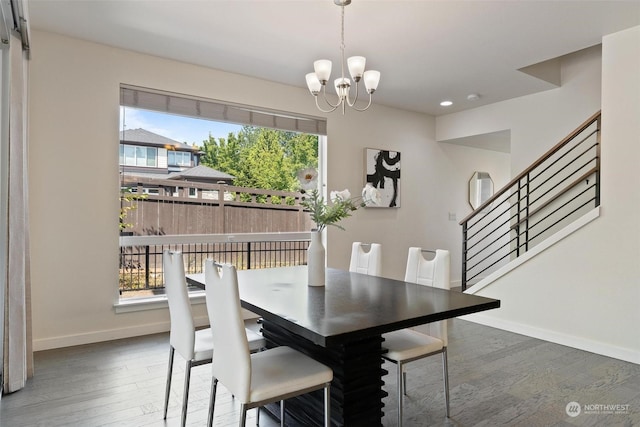 dining area featuring dark wood-type flooring and a notable chandelier