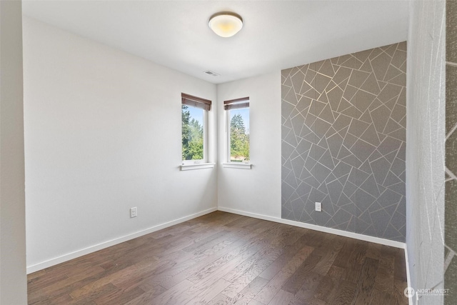 empty room with dark hardwood / wood-style flooring