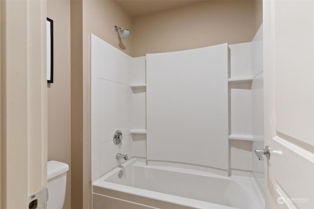 bathroom with bathtub / shower combination and toilet