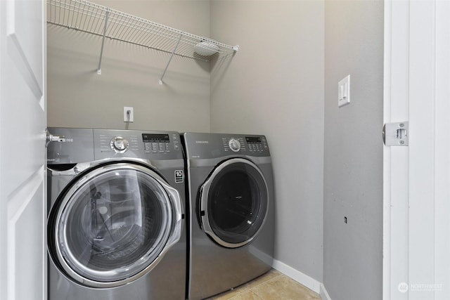 washroom featuring washer and dryer and light tile patterned flooring