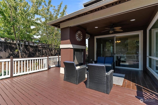 wooden deck featuring an outdoor living space with a fireplace and ceiling fan