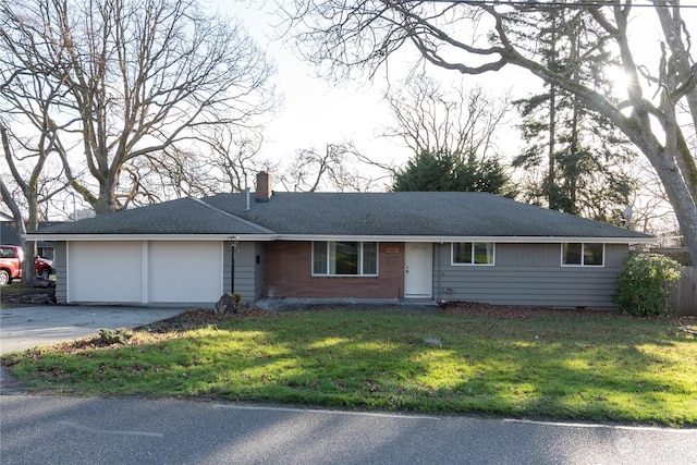 ranch-style house with a front yard and a garage