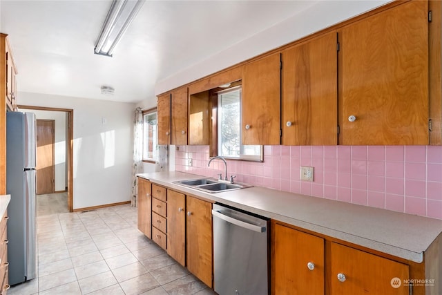 kitchen featuring light tile patterned flooring, sink, stainless steel appliances, and tasteful backsplash