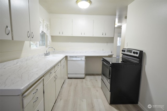 kitchen with white cabinetry, white dishwasher, a healthy amount of sunlight, and stainless steel electric range