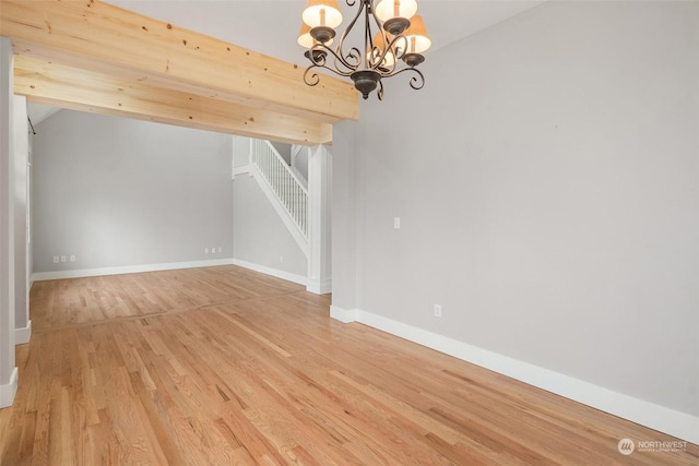 unfurnished dining area with light wood-type flooring and a chandelier