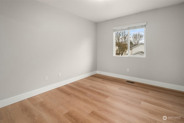 empty room with light hardwood / wood-style flooring