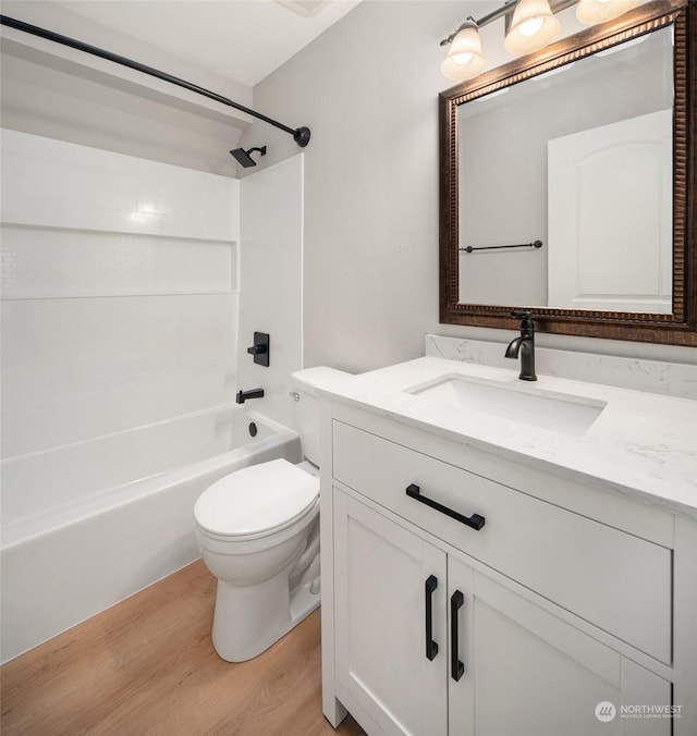 full bathroom featuring bathtub / shower combination, toilet, vanity, and hardwood / wood-style flooring