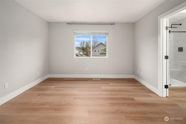 spare room featuring light wood-type flooring