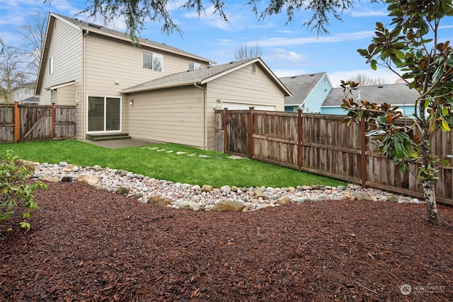 rear view of property featuring a yard