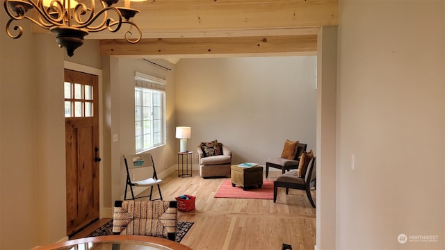 entrance foyer featuring hardwood / wood-style flooring and a notable chandelier