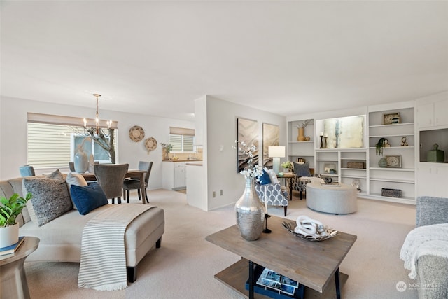 carpeted living room with a notable chandelier