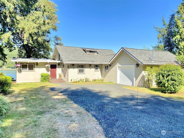 single story home featuring a garage and a front lawn