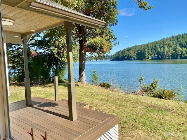 deck featuring a lawn and a water view