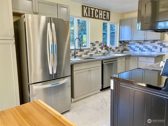 kitchen featuring gray cabinets, sink, appliances with stainless steel finishes, and tasteful backsplash