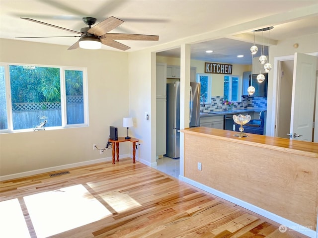 interior space with ceiling fan and light hardwood / wood-style flooring