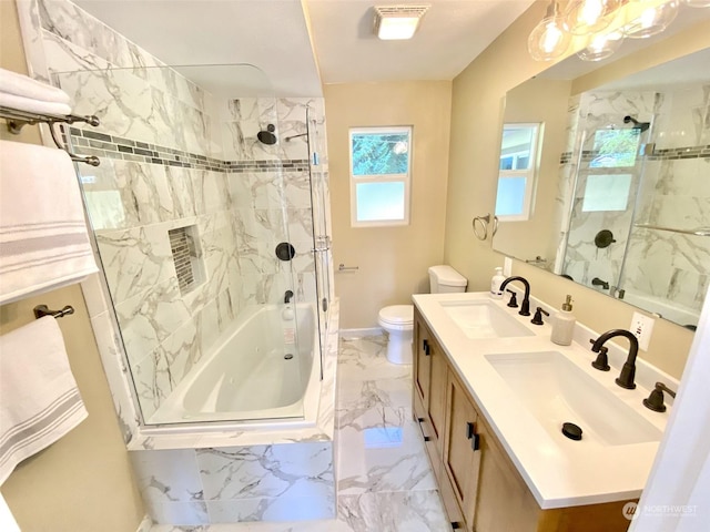 full bathroom featuring vanity, tiled shower / bath combo, and toilet