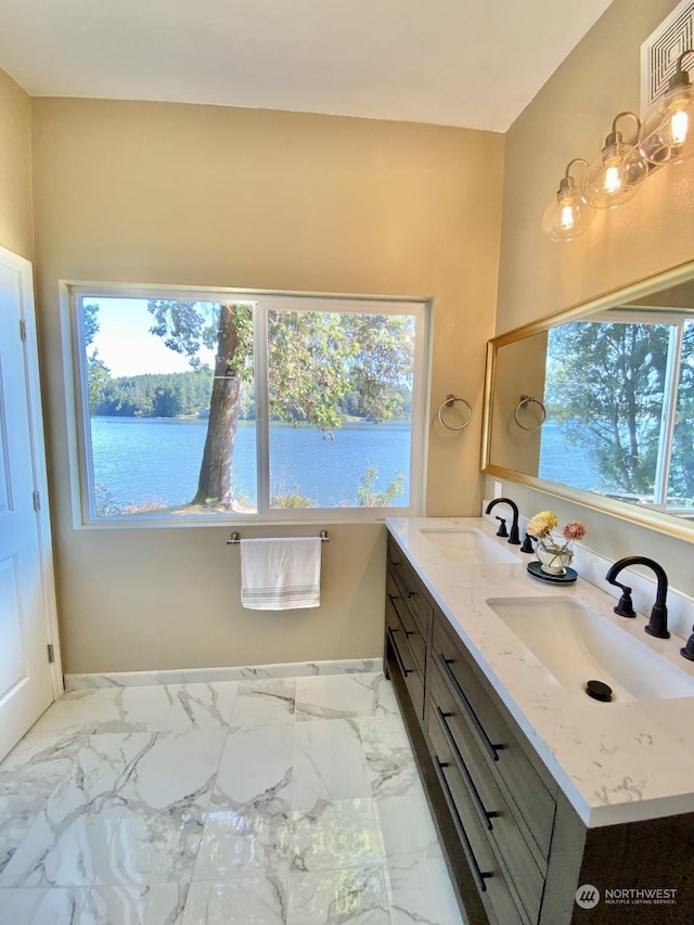 bathroom featuring vanity, plenty of natural light, and a water view