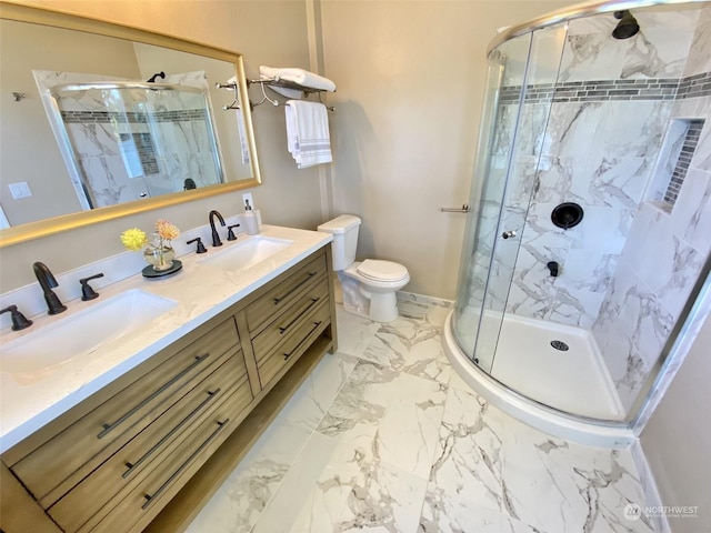 bathroom with vanity, toilet, and a shower with shower door