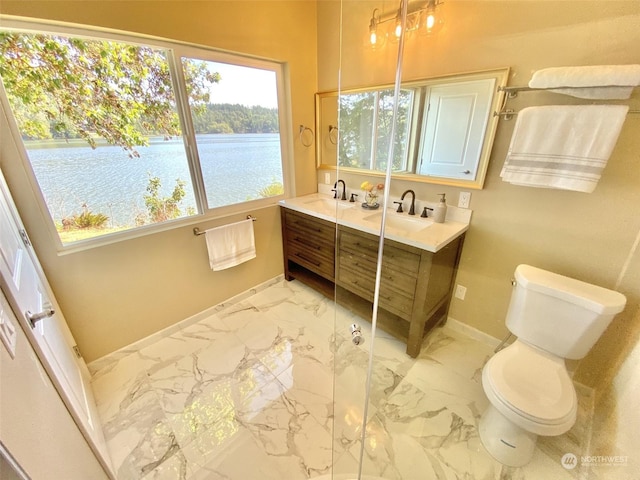 bathroom featuring vanity, a water view, and toilet