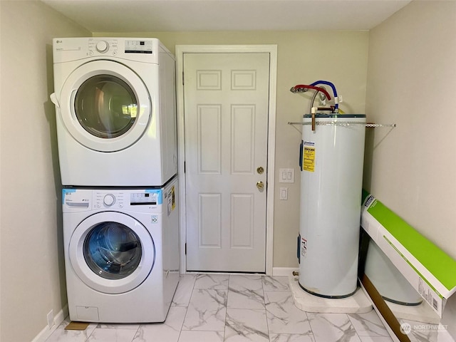 clothes washing area with stacked washing maching and dryer and water heater