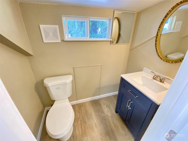 bathroom with vanity, wood-type flooring, and toilet