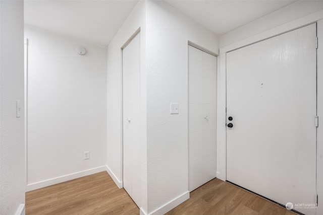 hall with light hardwood / wood-style floors