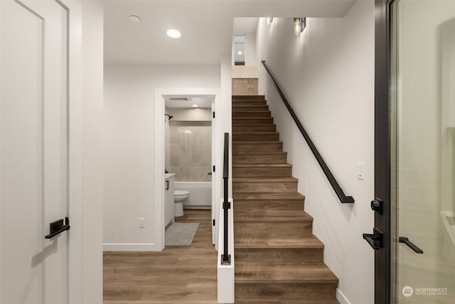 stairway with hardwood / wood-style flooring