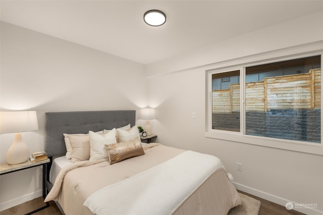 bedroom with dark hardwood / wood-style flooring