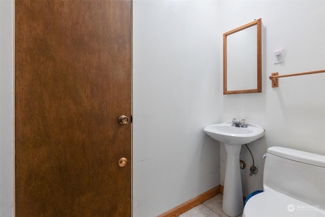 bathroom featuring toilet and tile patterned floors