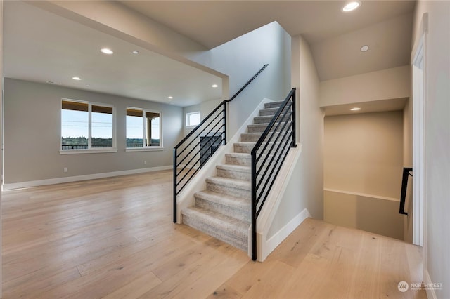 stairway with hardwood / wood-style floors