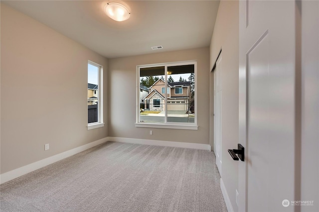 empty room featuring light colored carpet