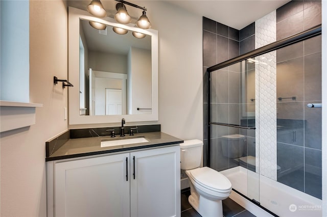 bathroom with walk in shower, tile patterned floors, vanity, and toilet