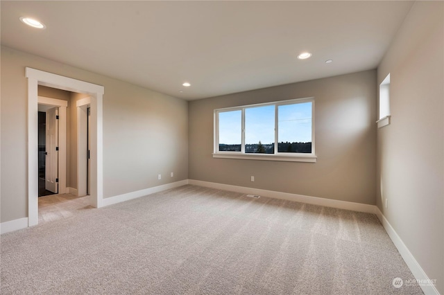 empty room with light colored carpet