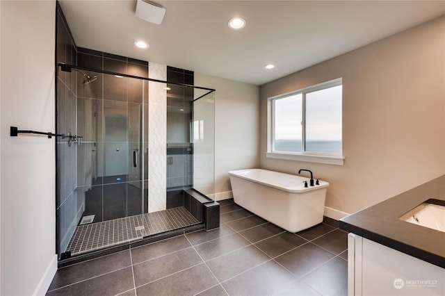 bathroom with vanity, independent shower and bath, and tile patterned flooring