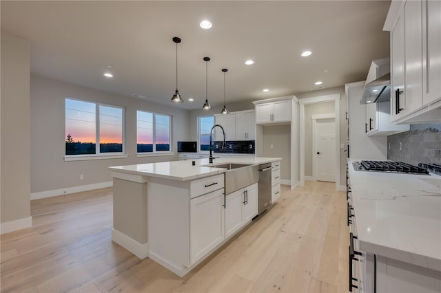20239 125th Ave NE Unit Sm2-11, Bothell, WA 98011 - kitchen with stainless steel dishwasher, light wood-type flooring, wall chimney exhaust hood, and tasteful backsplash