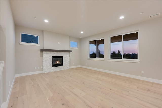 20239 125th Ave NE Unit Sm2-11, Bothell, WA 98011 - unfurnished living room featuring a fireplace, light wood-style flooring, recessed lighting, baseboards, and visible vents